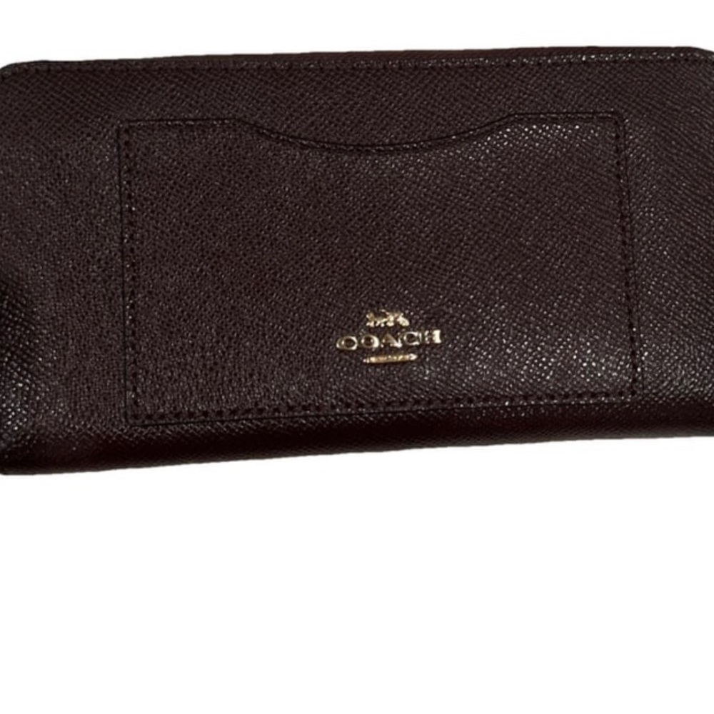 Brown leather Coach zippy wallet.